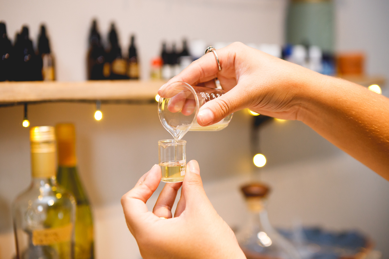 brazilian woman making natural perfumes in her workshop